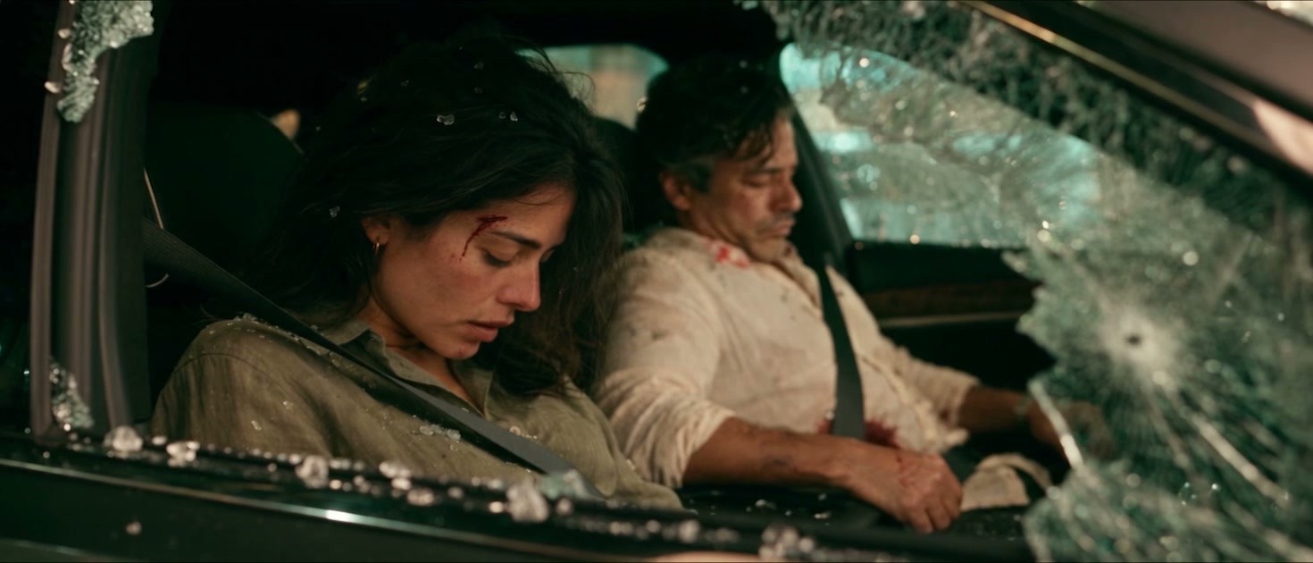 Valeria y Julián inconscientes en el auto, con el vidrio de la ventanilla estrellado y fragmentos sobre el tablero.