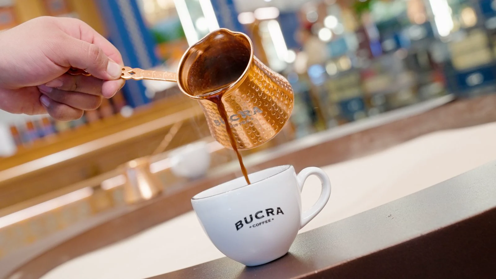Digital content for Bucra Coffee produced by ZerezoFilms: pot coffee poured from a copper cezve into a white cup