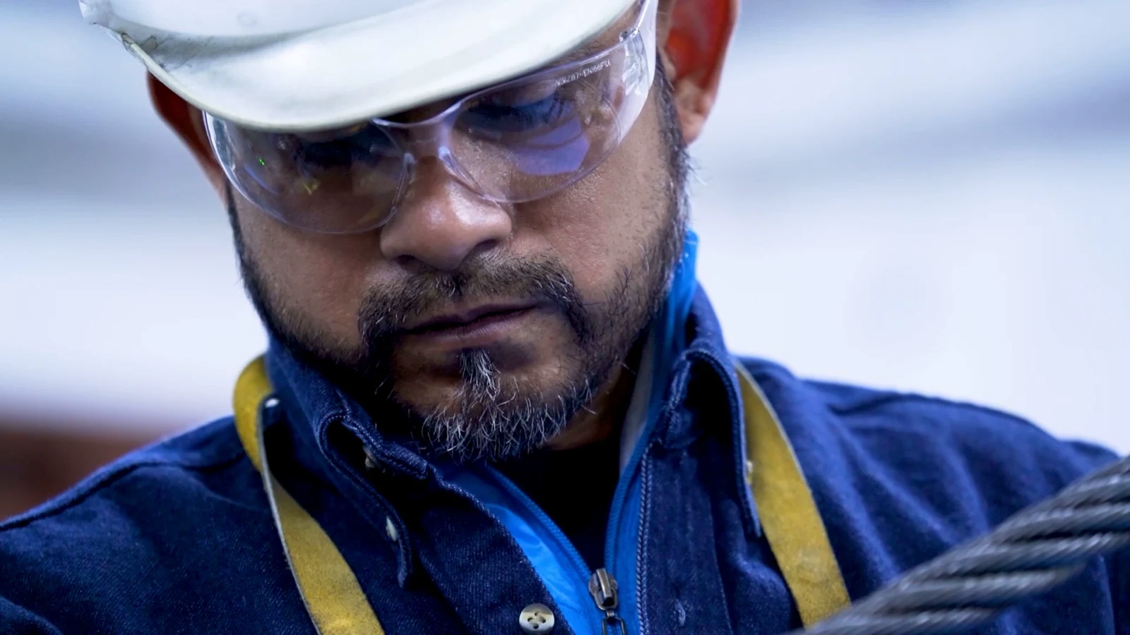 Industrial corporate video produced by ZerezoFilms: technician with a hard hat and safety glasses at a plant